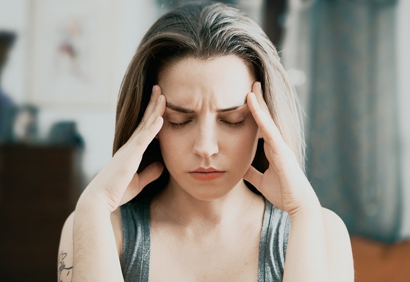 young woman with a migraine
