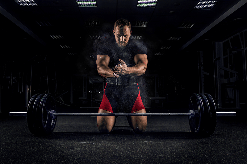 A man preparing to life a large weight bar