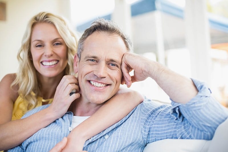 Happy couple hugging on the couch