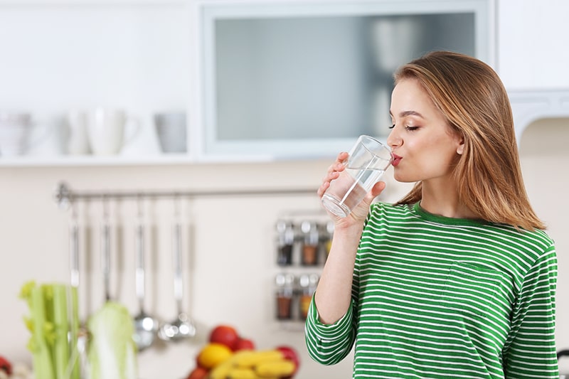 Young woman drinking new "Clear Coffee" a New Tooth-Healthy drink