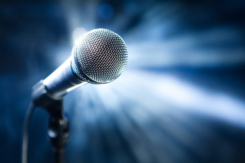 A single microphone on a stage with a bright blue background. Just like in American Idol, there can only be 1 winner. When you visit Dr. Pamela Marzban in Burke, VA you'll receive a #1 smile, unique just to you.