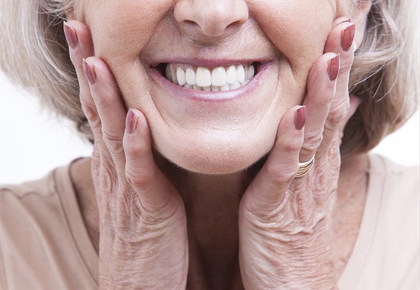 Close up view on senior with a great smile. Replacing metal fillings is often a simple process. We remove the old filling and put in a new composite tooth-colored filling. Composite fillings can be placed, hardened, and polished in a single visit. You can come in with metal fillings and leave with new tooth-colored fillings.
